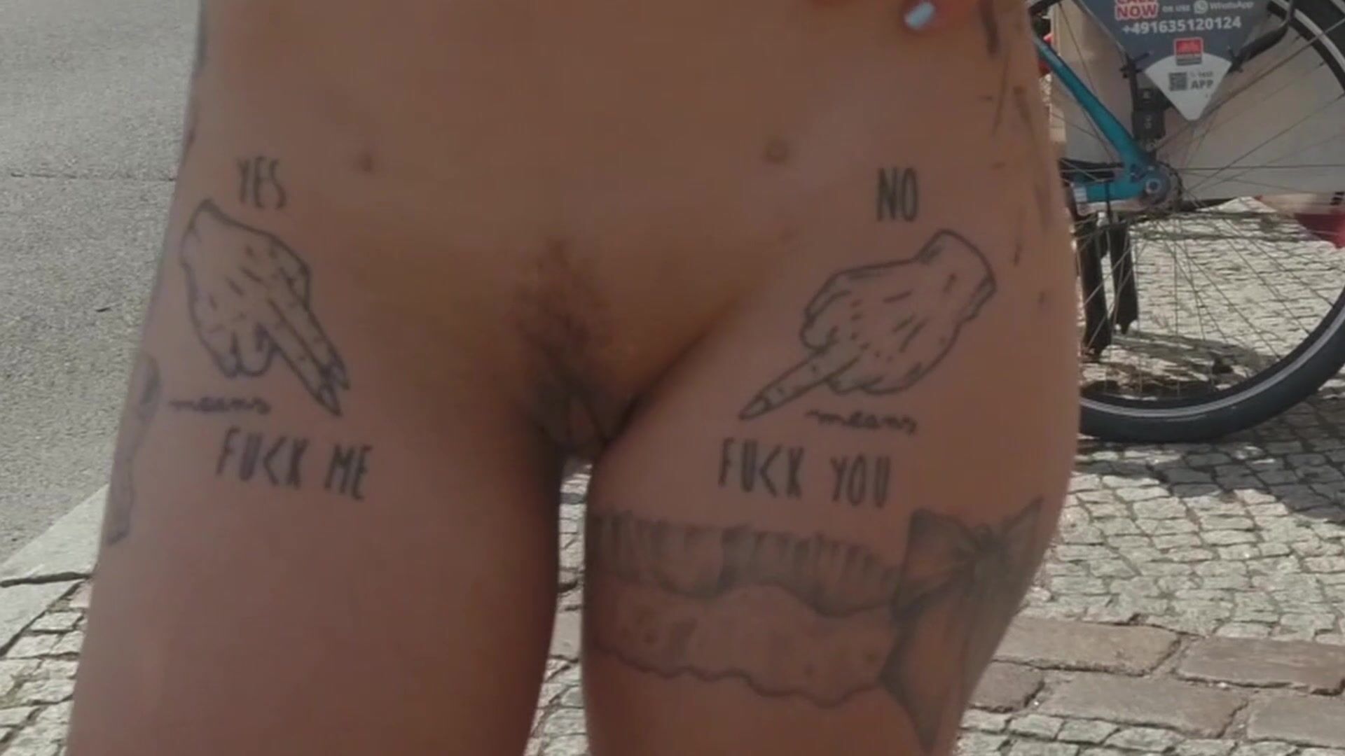 Showing off her tattoos to the whole city