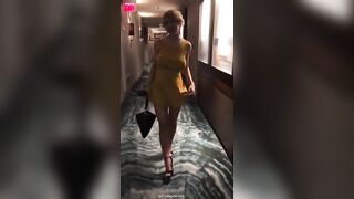 Busty blonde removes dress in hotel hallway