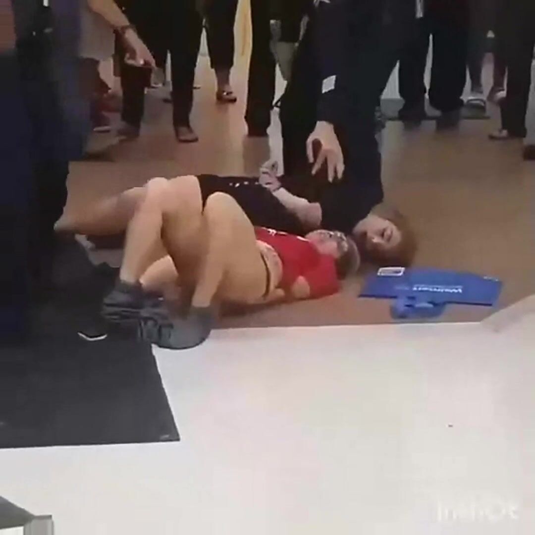 Two girls protesting getting removed from shopping mall